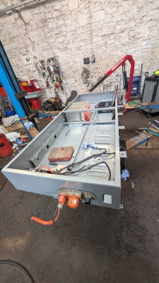 Battery box back from powder coating and first stack installed.