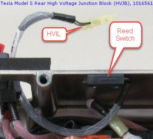 Closeup of Tesla Model S GEN1 HVJB (under rear seat), lid removed, showing the HVIL cover reed switch and HVIL connector that connects to a mating connector on the OBC.